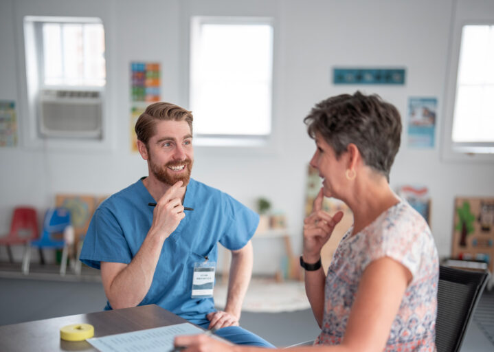 Speech therapist helping senior patient